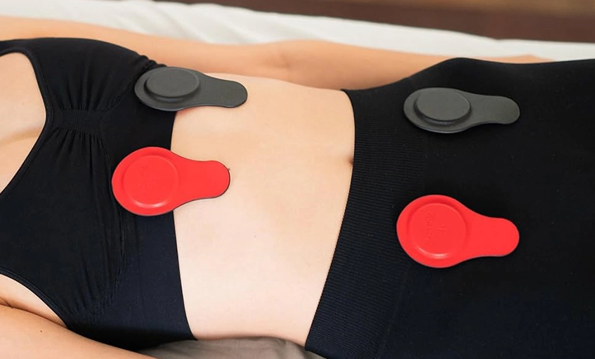 Person Receiving Magnetic Therapy with Devices on Abdomen